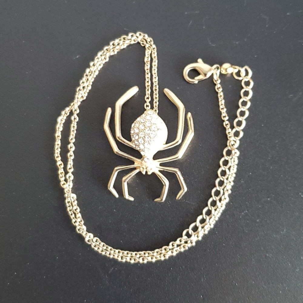 Gold- colored necklace with spider pendant